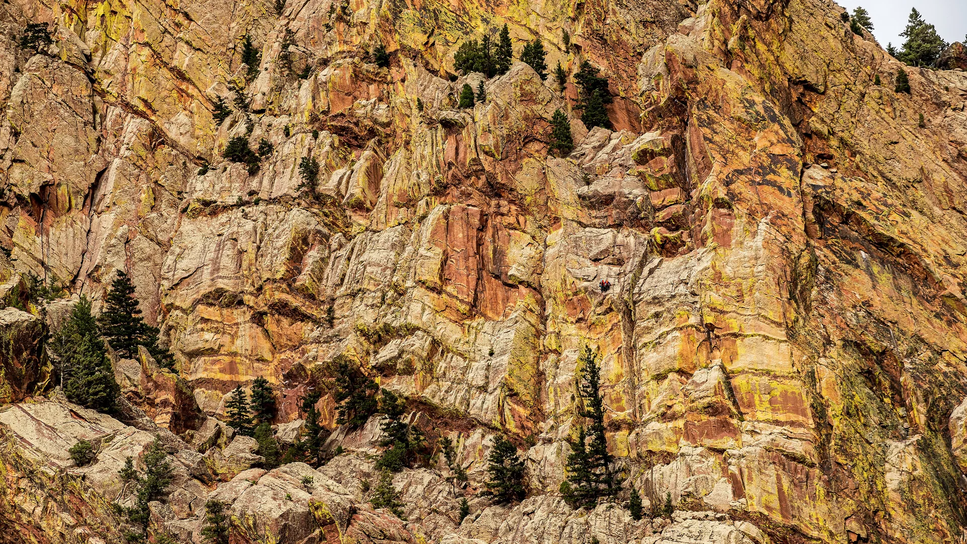 Kletterer in den steilen goldbraunen Felswänden des Eldorado Canyon State Park