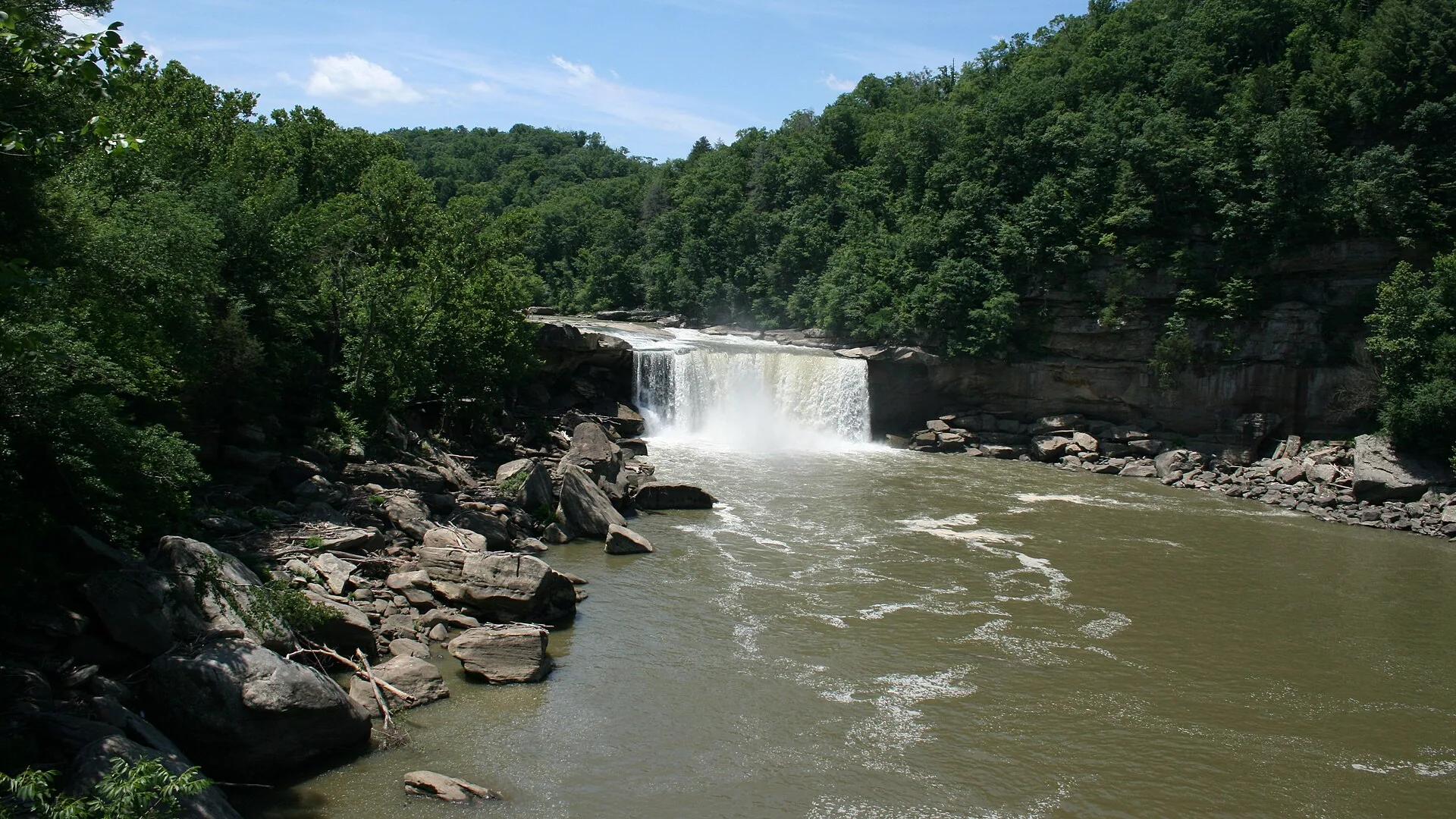 Breiter Cumberland Falls stürzt zwischen bewaldeten Felsufern in den Fluss