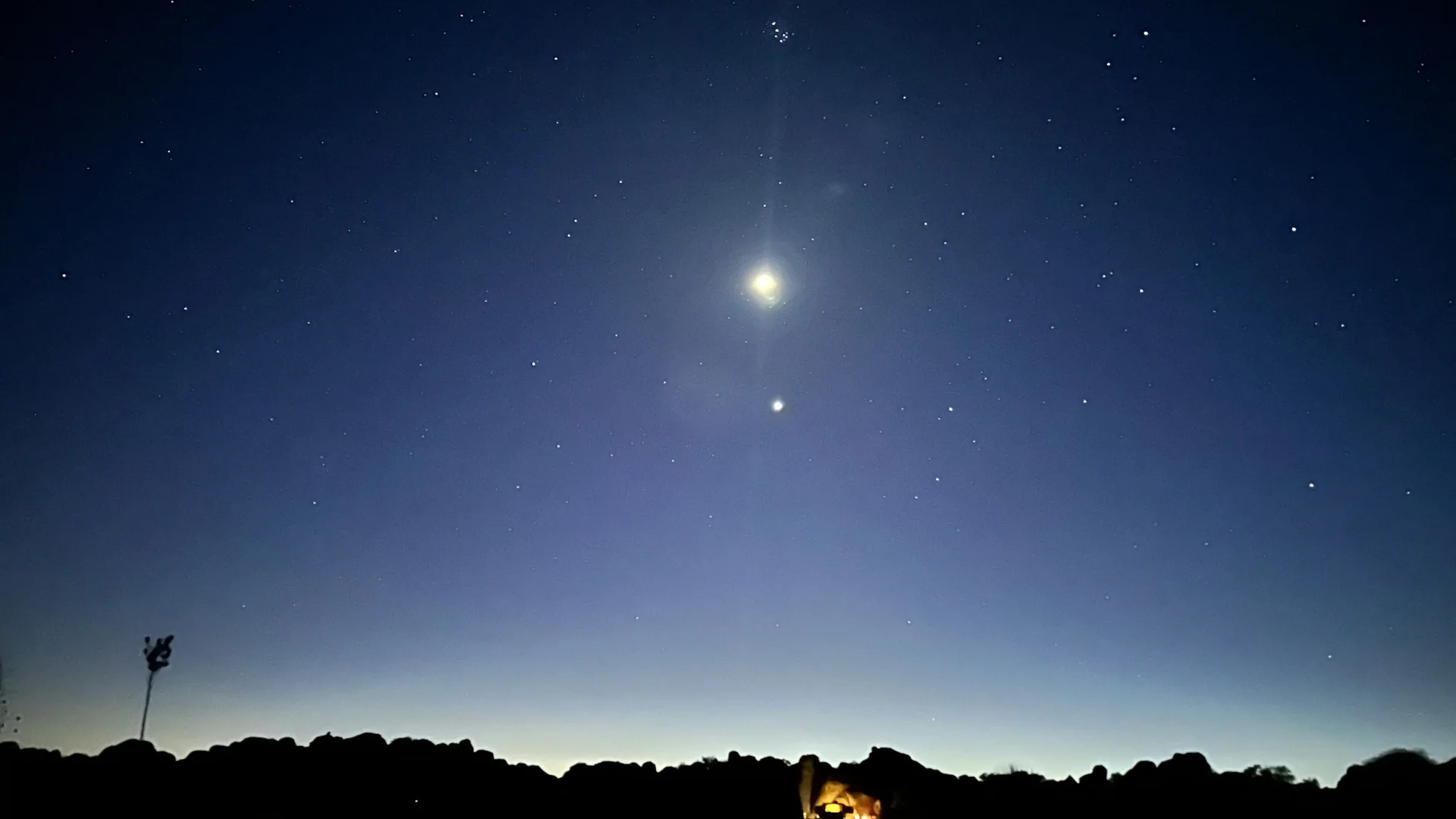 Sterne und helle Planeten über den dunklen Felssilhouetten im City of Rocks State Park