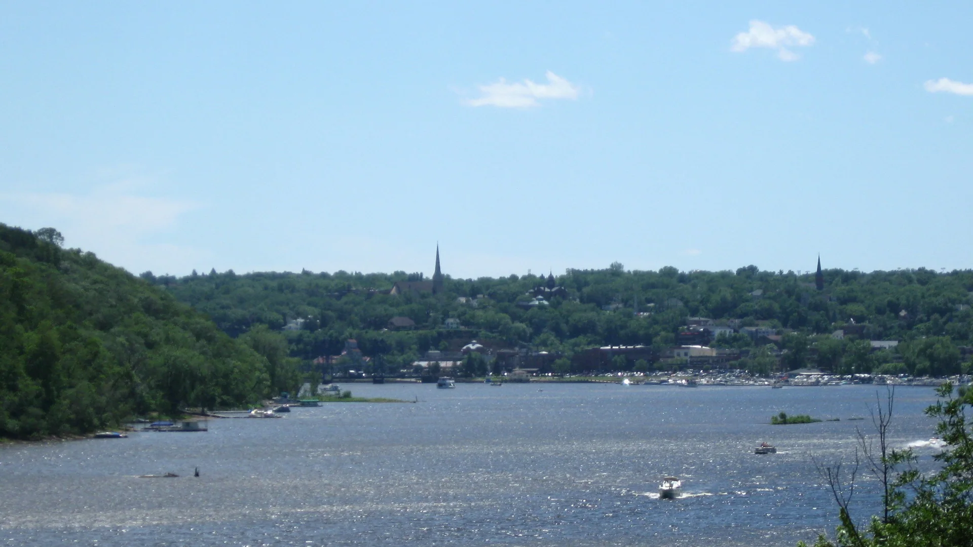 Weiter Sommerblick über den St. Croix River mit Booten und bewaldeten Ufern