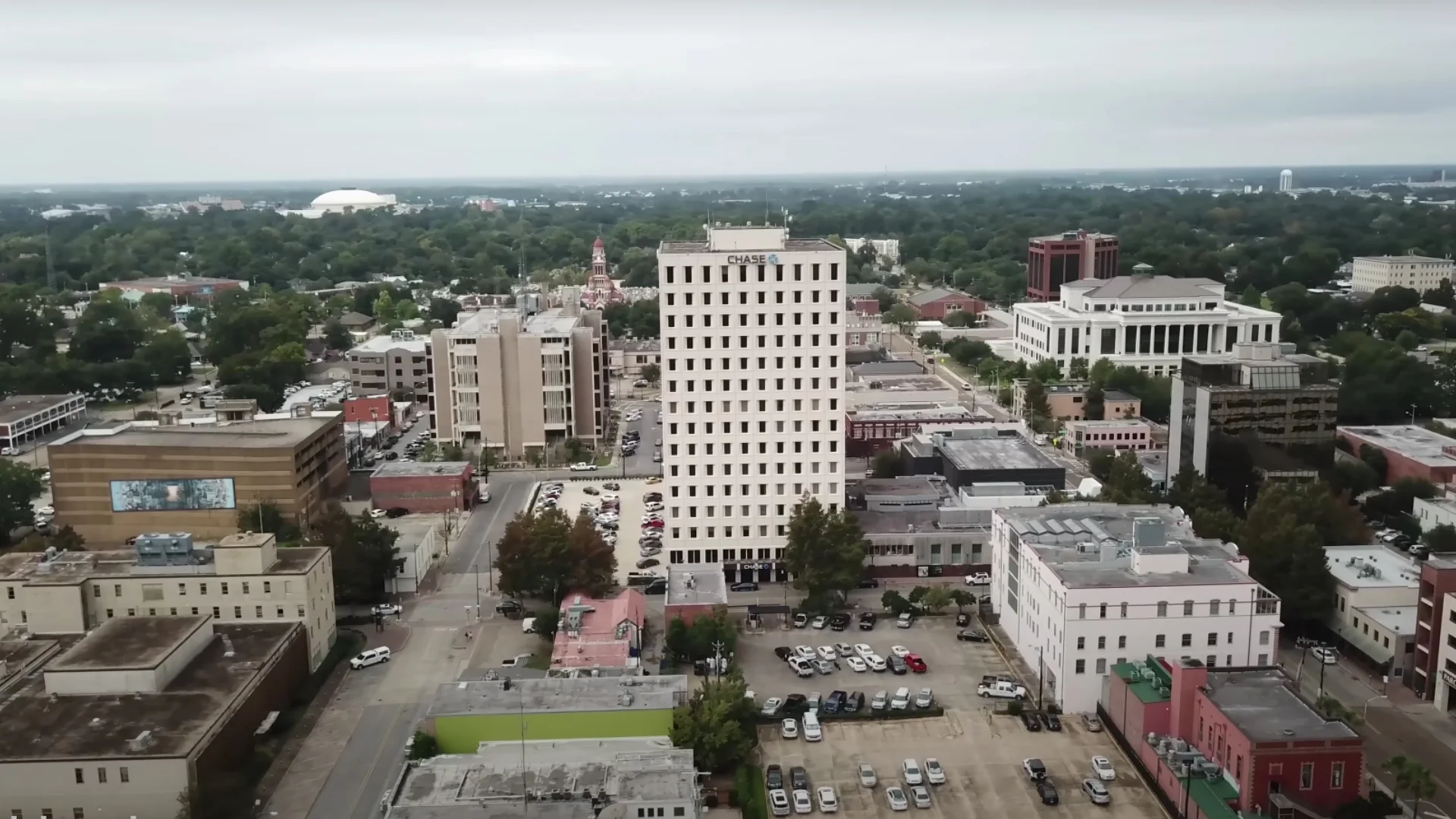 This is an image of the skyline of Downtown in Lafayette, Louisiana, in the United States of America. The Chase Bank tower is at center. To left of the Chase Tower, the shorter highrise is the Lafayette Parish Courthouse. The spire of the Cathedral of St. John the Evangelist seen in distance above. The Shaw Courthouse at upper center right. The Cajundome seen in the distance at upper left.