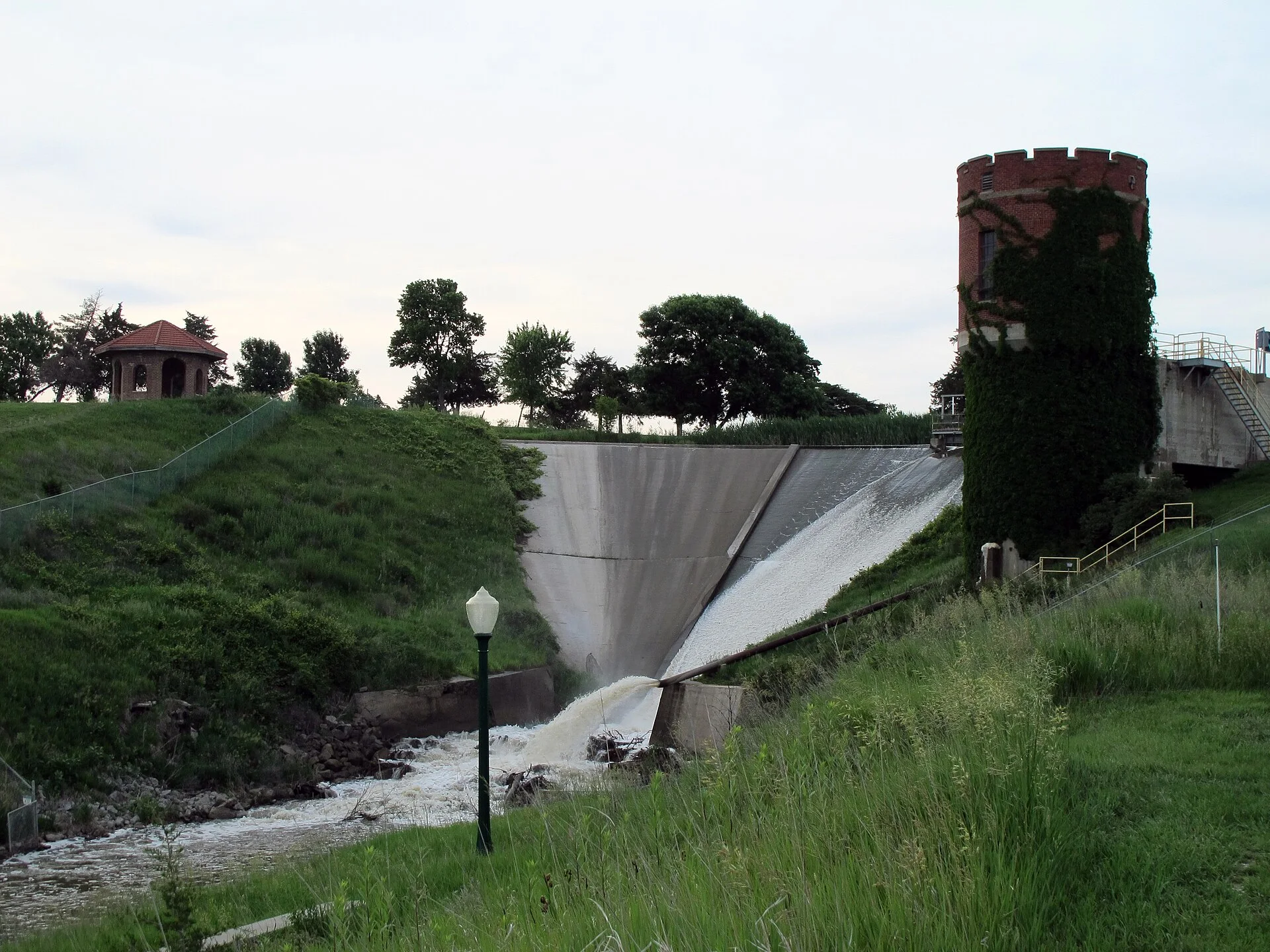Photo of Kearney Dam (and the Kearney Canal), near the University of Nebraska-Kearney campus in Kearney, Nebraska. Photo is looking north-northwest at the face of the dam (south-facing dam; nearly due north of 15th Avenue & University Drive).
