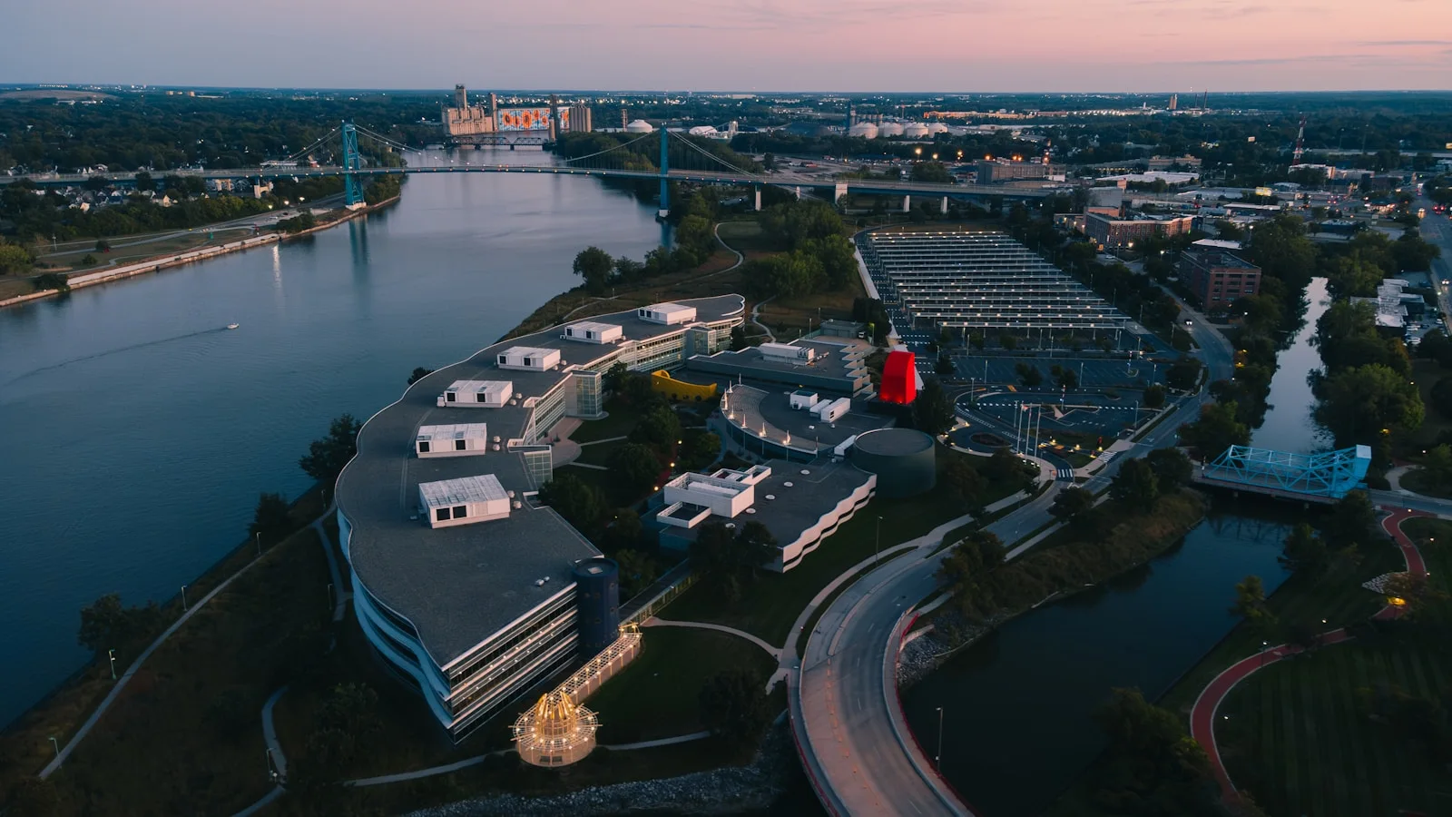 Aerial view of a modern office building complex by a river.