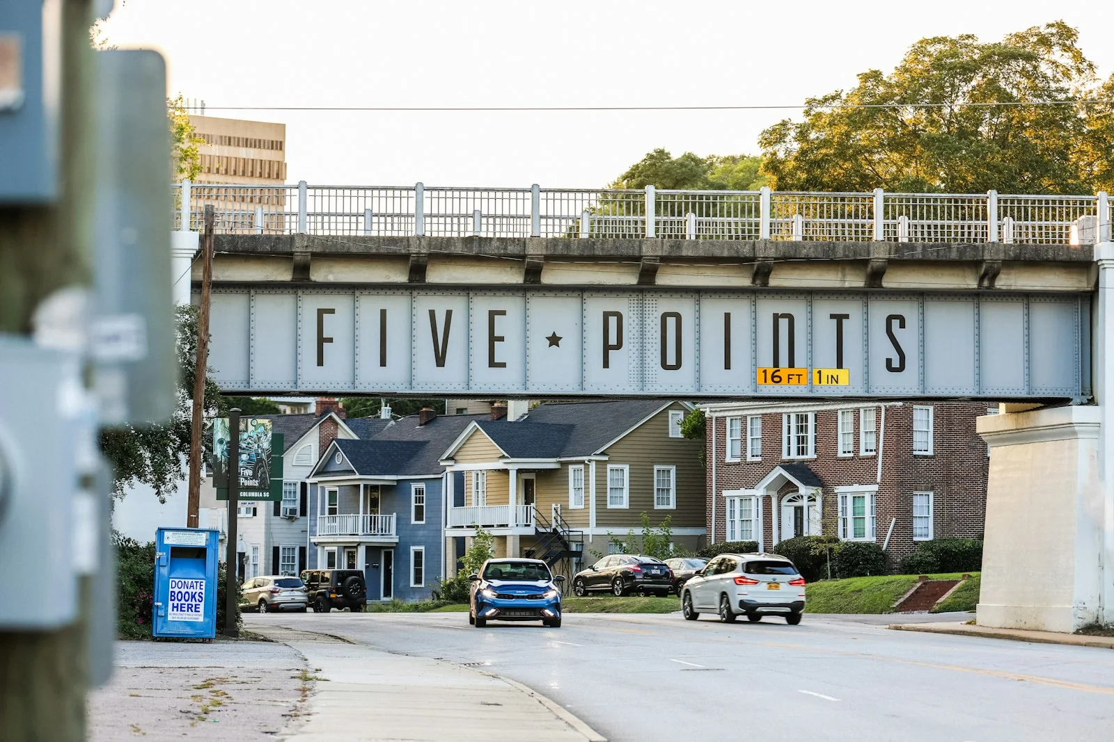 a bridge over a street with cars driving under it
