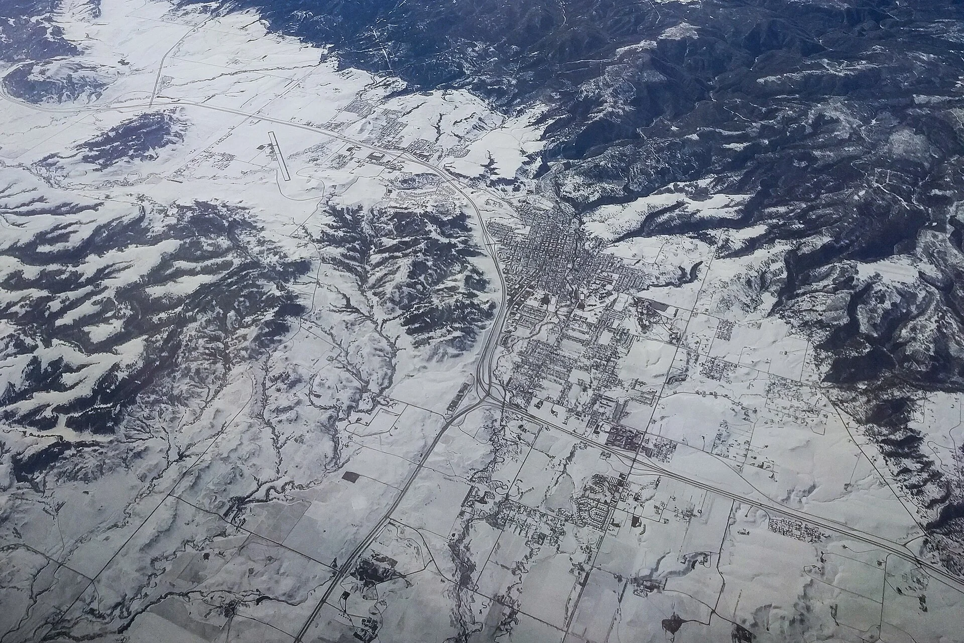 Spearfish, South Dakota, as seen from 35,000 feet. I-90 from bottom right to top left, US Route 85 from the bottom left, Clyde Ice Field airport on the top left.