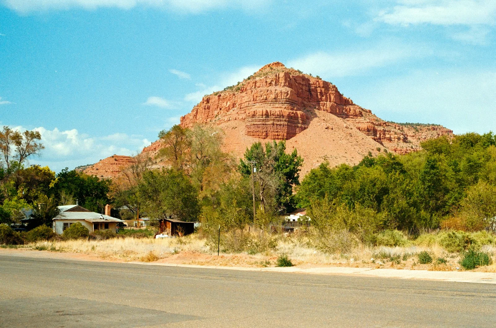 Red rock mountain overlooks a small desert town.